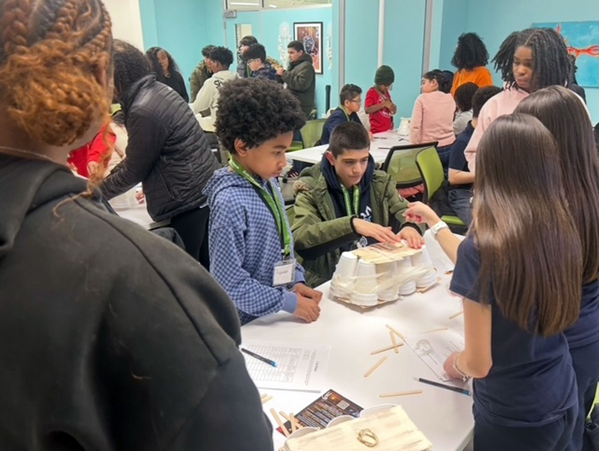 Students working at a table on a STEM activity